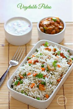 vegetable pulao served with yogurt sauce and fresh vegetables on the side