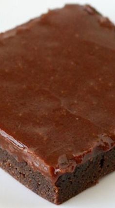 a piece of chocolate cake sitting on top of a white plate