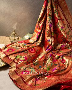 Cast a spell with our handpicked Gold Paithani Silk Tissue all over gold, hailing from Maharashtra! The Gold body of the handwoven tissue silk features multi-colored floral jaal and lush green leaves. The statement pallu comes with a self zari and features rows of muniya motifs. #paithani #paithanisaree #paithanisilk #silk #saree #paithanisilksaree #weavesofindia #indianhandloom #handwovensaree #sareefashion #sareelove #Kankatala #queenofsarees Silk Tissue Saree, Haldi Kumkum, Dresses Traditional, Kota Sarees, Wedding Backdrop Decorations, Tissue Saree, Cast A Spell, Indian Dresses Traditional