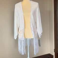 This Is A Beautiful Fringed Sweater From Ny Collection. It Is An Acrylic Nylon Blend Size Medium It Is New With Tags. Measurements : From Pit To Pit Is 19 Inches Length Is 31 Inches To The Very Tip Of The Fringe It Is A Drop Shoulder And Has Three-Quarter Length Sleeves Summer Cotton Fringe Outerwear, Summer White Knit Outerwear, Casual Summer Fringe Cardigan, Casual White Cardigan For Festival, White Spring Outerwear For Vacation, White Spring Vacation Outerwear, Trendy White Beach Outerwear, White Cotton Summer Cardigan, White Cotton Cardigan For Vacation