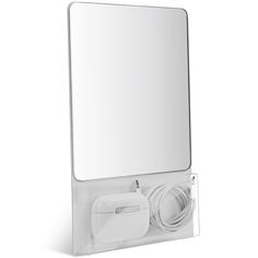 an image of a bathroom mirror and plugged in charger on the wall mounted