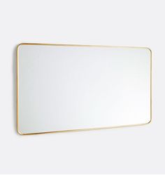 a white and gold framed mirror on the wall