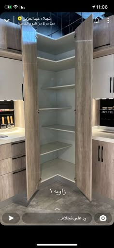 an open cabinet in the middle of a kitchen