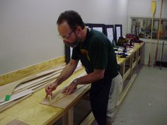 a man working on woodworking in his workshop