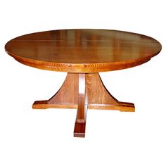 a round wooden table with two leaves on it