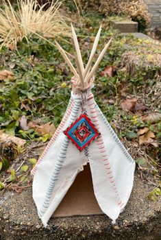 a teepee sitting on top of a cement block