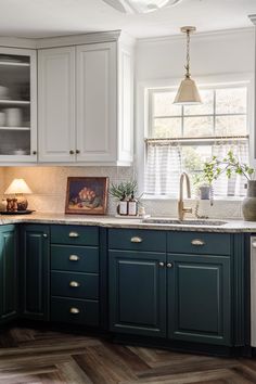 a kitchen with green cabinets and white appliances