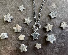 "A sweet tiny textured star fossil necklace pendant ... a crinoid star fossil ... endlessly interesting historic fossil jewelry. They're also called sea lily fossils and date back up to 201 million years ago, perhaps even earlier and believe it or not they are very common fossils if you look in the right places.  They were sea animals, like sea stars and sea urchins.  You've probably seen them in Victorian imagery - 5th photo.   We are all of us stars, and we deserve to twinkle ... Marilyn Monro Sea Urchin Jewelry, Crinoid Fossil, Fossil Earrings, Wax Seal Pendant, Fossil Jewelry, Sea Jewelry, Antique Wax, Tiny Star, Shiny Silver