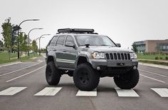 a jeep is parked in the middle of an empty parking lot