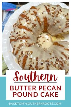 a white plate topped with a bundt cake covered in frosting and pecans