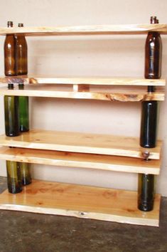 three wooden shelves with bottles on them