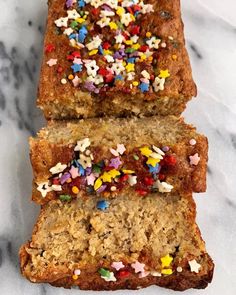 three slices of cake with sprinkles on them sitting on a marble surface