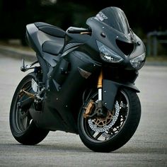 a black motorcycle parked on the side of a road