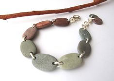 Beautiful bracelet made of misty green and brown Mediterranean beach stones... Very comfortable, very sturdy and full of spirit! Great gift idea for nature lovers. All metal parts are sterling plated. The closure is lobster clasp. Max. adjustable length is: 19 cm. ★ Ready to ship via Registered Express Airmail. You can UPGRADE to UPS (delivery in 3-4 days) if you like faster delivery. ★ For more yummy pebble, river rock jewelry making supplies StoneAlone.etsy.com 5367 Diy Rock Jewelry, Earthy Natural Stones Jewelry For Beach, Rock Jewelry Diy, Green Earthy Bracelets With Natural Stones, River Rock Jewelry, Earthy Green Bracelets With Natural Stones, Earthy Hand-wrapped Bracelets For The Beach, Brown Natural Stones Beach Jewelry, Beach Pebble Jewelry