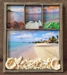 shells and seashells are arranged in a shadow box on the sand at the beach