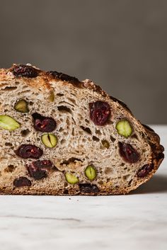 a piece of bread with cranberry pistachio and white chocolate on it