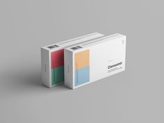 two boxes with different colored labels on them sitting side by side against a gray background