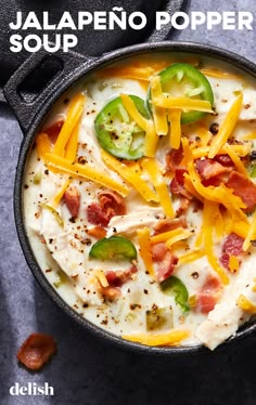 a bowl of jalapeno popper soup with cheese and green peppers on top