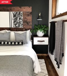 a bedroom with black and white decor on the walls, wood headboard and bedding