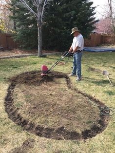 a man is using a lawn mower to cut the grass in a circle shape