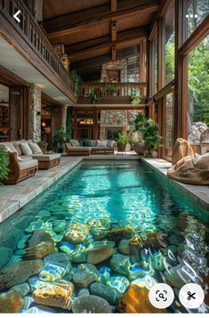 an indoor swimming pool with rocks in the middle and water running down it's sides