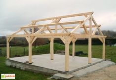 a wooden structure sitting on top of a cement slab