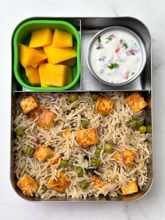 a lunch box with rice, peas and tofu