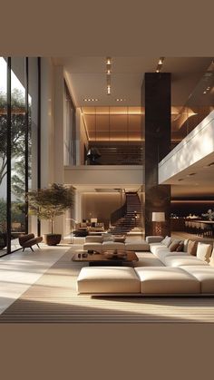 a large living room with white couches and lots of windows on the side of it