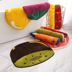 bathroom rugs in various colors and designs on the counter top next to a bathtub