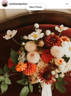 a bouquet of flowers sitting on top of a wooden chair