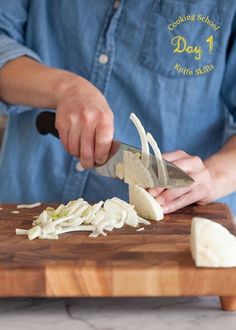 a person cutting up some food on top of a wooden cutting board with a knife