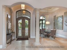 an elegant entry way leading to a formal dining room