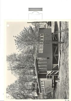 an old black and white photo of a house with stairs leading up to the roof