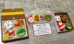 three different cards with snowmen and other items in them on a wooden table top