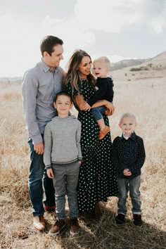 a family posing for a photo in a field