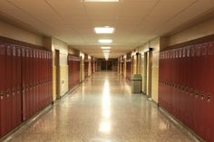 an empty hallway with red lockers in the middle stock photo - image 399784