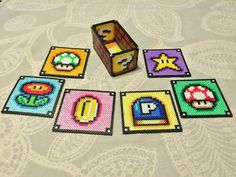 a table topped with lots of different types of nintendo coasters next to each other