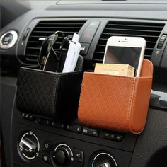 cell phone and wallet holder in the dash of a car with other items on it