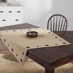 a wooden table topped with a place mat and a bowl on top of the table