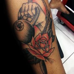 a tattoo on the arm of a man with a rose and scissors in his hand