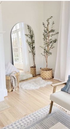 a living room with white walls and wooden floors