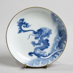 a blue and white plate with a dragon on it