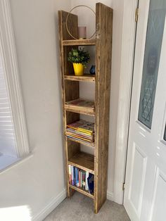 a tall wooden shelf sitting next to a door