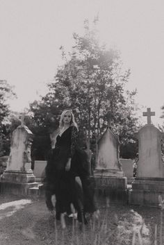 black and white photograph of woman in cemetery