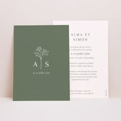 the front and back of a wedding card with a tree on it, in white ink