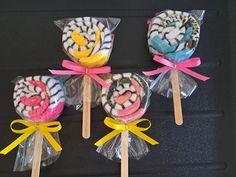 four lollipops wrapped in cellophane and tied with ribbon