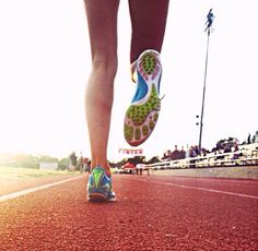 a person running on a track with their feet in the air