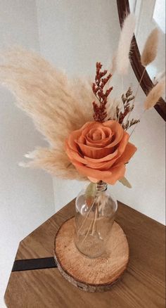 an arrangement of dried flowers in a glass vase