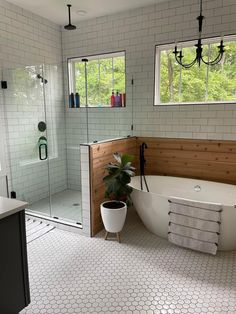 a bathroom with a tub, sink and shower in it's own area is shown