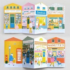 an open book with illustrations of shops and people